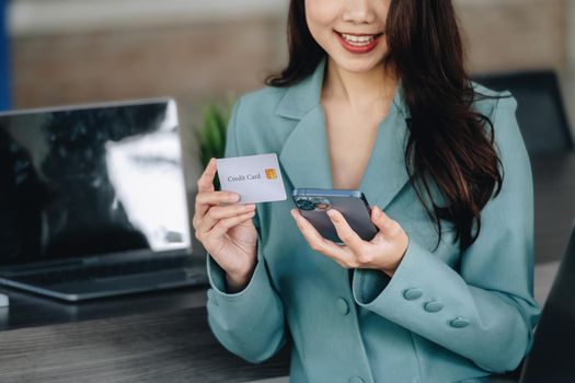 Online Shopping and Internet Payments, Beautiful Asian women are using their credit cards and mobile phones to shop online or conduct errands in the digital world