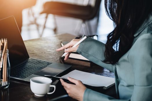 Finance and Investment Concepts, Female entrepreneurs are holding pen to start analyzing financial statements to increase investment by using computers and notebooks to work