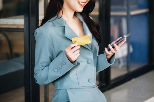 Online Shopping and Internet Payments, Beautiful Asian women are using their credit cards and mobile phones to shop online or conduct errands in the digital world