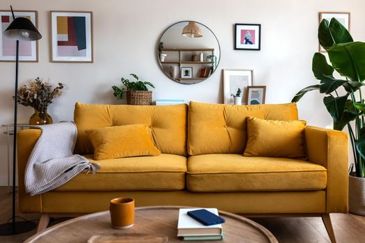 Front view of yellow couch in living room apartment interior. Contemporary family home.