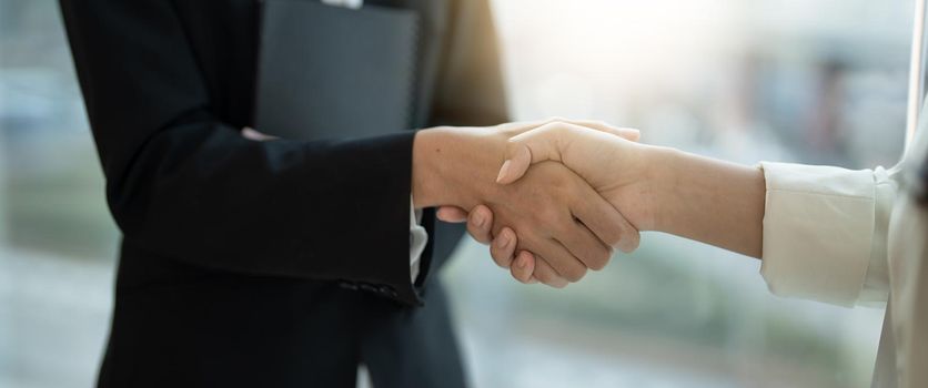 Close up of Business people shaking hands, finishing up meeting, business etiquette, congratulation, merger and acquisition concept.