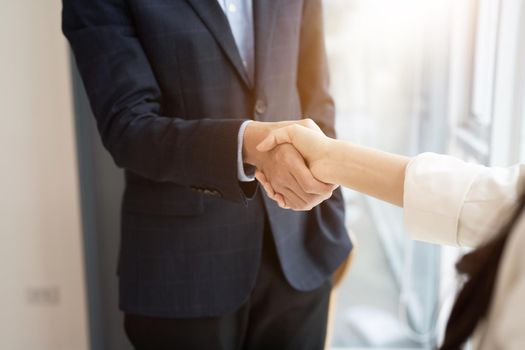 Business asian agreement and successful negotiation concept, businessman in suit shake hand with customer, client after formal communication and contract deal success.