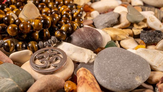 Buddhist prayer beads Mala lying on the sea rocks. close-up color