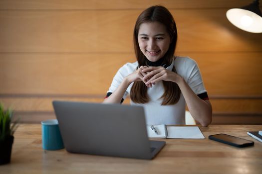 Asian woman working or learning on laptop indoors- educational course or training, seminar, education online concept