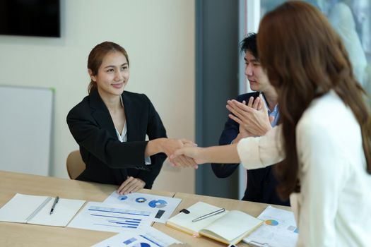 Business asian people shaking hands, finishing up meeting, business etiquette, congratulation, merger and acquisition concept.