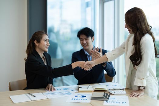 Business asian people shaking hands, finishing up meeting, business etiquette, congratulation, merger and acquisition concept.