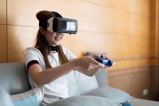 close up happy emotion asian woman playing video games with controller on abstract background toned with virtual glasses.