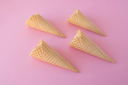 Creative photo of empty waffle cones on a pink background