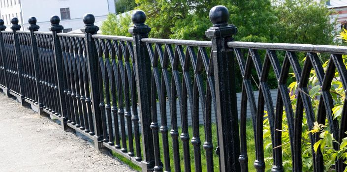 Black forged fence on a granite base.