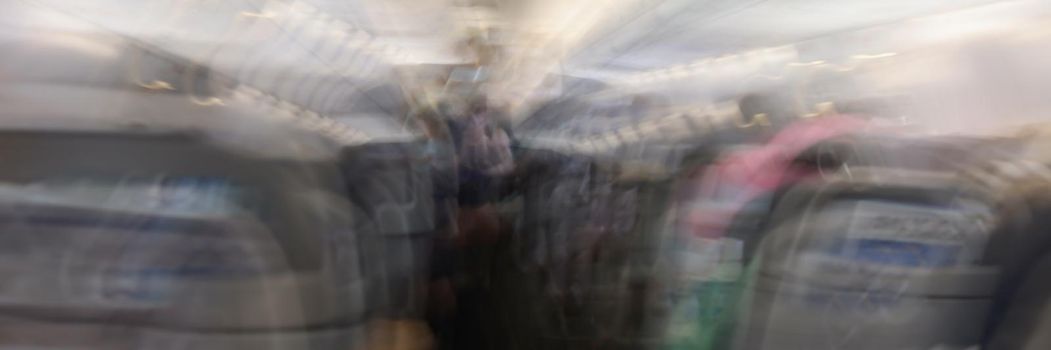 Plane shakes during turbulence flying air hole, blur image commercial plane moving fast downwards. Fear of flying, agoraphobia, depression, downfall, panic concept