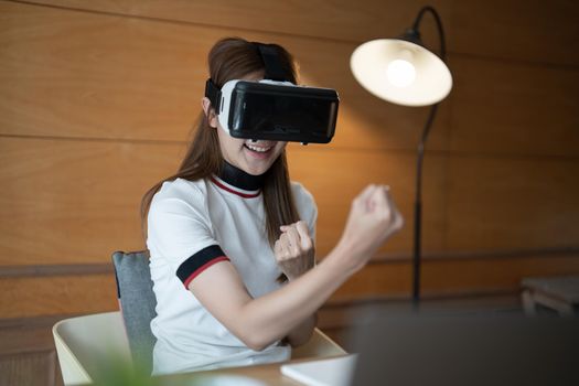 Photo of young asian woman cheerful guy have fun celebrate victory win game goggles ay her home.