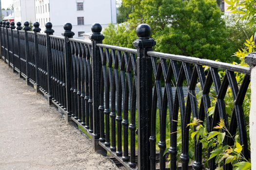 Black forged fence on a granite base.