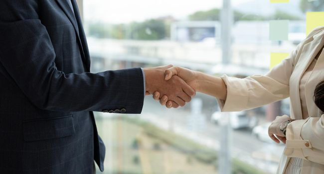 Business asian agreement and successful negotiation concept, businessman in suit shake hand with customer, client after formal communication and contract deal success.