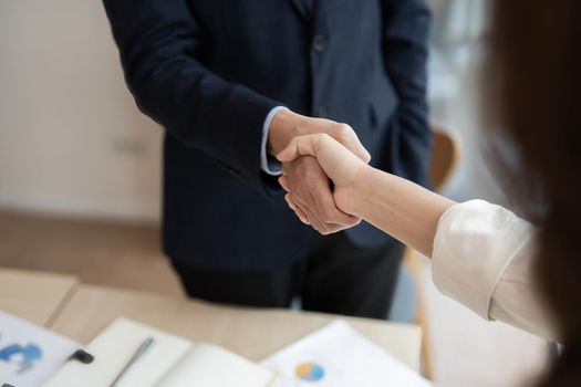 Business asian agreement and successful negotiation concept, businessman in suit shake hand with customer, client after formal communication and contract deal success.