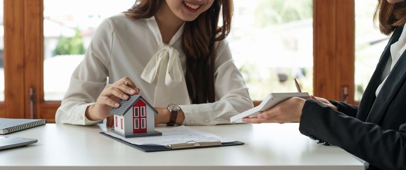 Real estate agent or bank officer describes the loan interest to the customer with home purchase contracts or on office loans and interest rates.