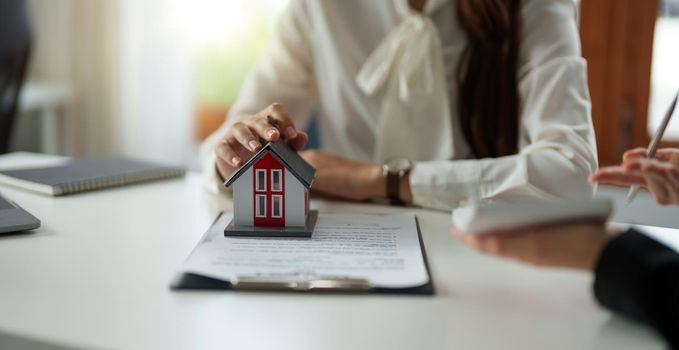 Real estate agent or bank officer describes the loan interest to the customer with home purchase contracts or on office loans and interest rates.