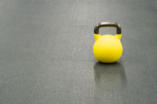 Yellow kettlebell weight healthy concept, from gym fit in strength and health activity, cross raining. Pace pound tudio, physical dumbbell black fresh black background object