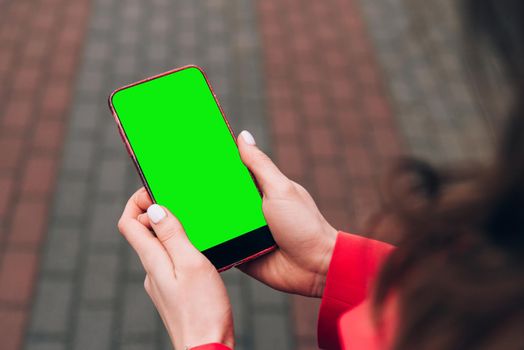 Cropped shot view of woman's hands holding smart phone with blank copy space screen for your text message or information content, female reading text message.