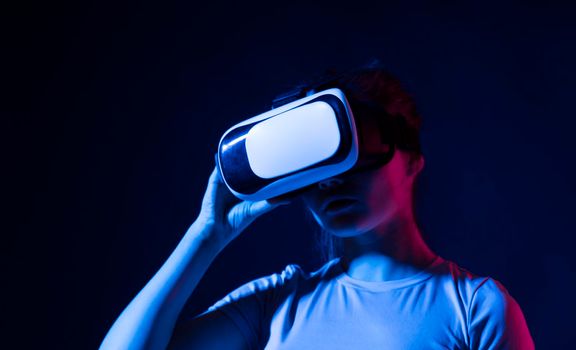 Young woman developer, designer or architector using VR headset to designing a new products or technologies using VR technology. Future technology concept