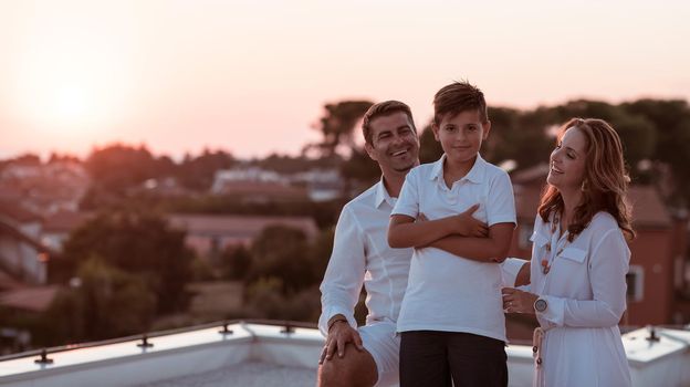 The happy family enjoys and spends time together on the roof of the house. Selective focus. High-quality photo