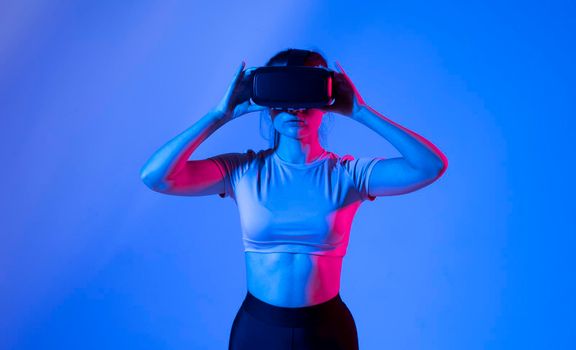 Woman wearing vr headset and watching 360 videos. Woman toching virtual objects in vr glasses