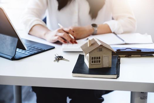 Entrepreneurs, business owners, accountants, real estate agents, focusing on tabletop home models with women using home equity budget calculators to assess their financial risks