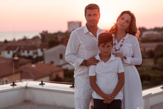 The happy family enjoys and spends time together on the roof of the house. Selective focus. High-quality photo