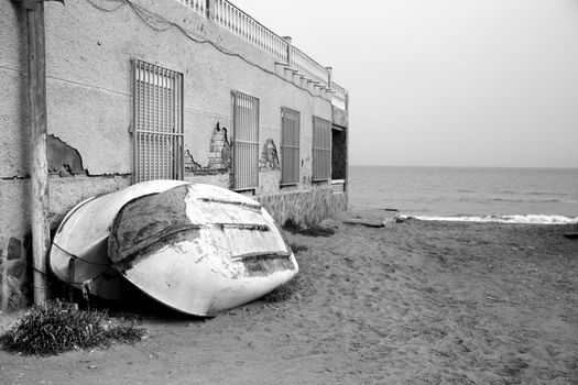Boats next to houses on El Pinet beach, Alicante, Spain. Monochrome picture.