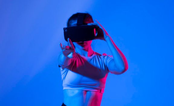 Woman wearing vr headset and watching 360 videos. Woman toching virtual objects in vr glasses