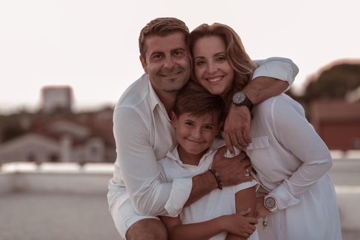 The happy family enjoys and spends time together on the roof of the house. Selective focus. High-quality photo