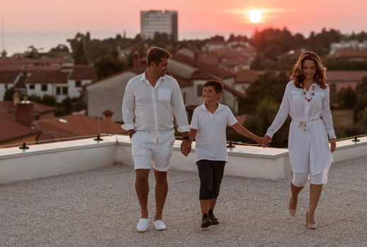 The happy family enjoys and spends time together on the roof of the house. Selective focus. High-quality photo