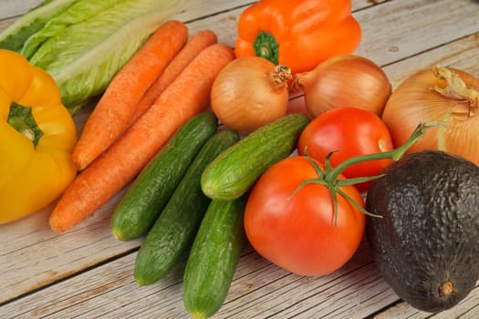 High Angle View of a Variety of Fresh Summer Vegetables or Garden Salad Ingredients on a Rustic Wooden Table