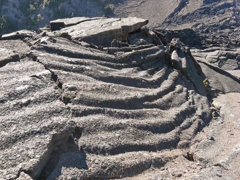 Solidified and cooled Pahoehoe Lava along Kilauea Iki Trail at Volcanoes National Park in Hawaii makes tapestry like folds