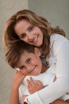 A portrait photo of an older woman in an embrace with her young son. Selective focus. High-quality photo