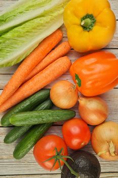 Directly Above Flat Lay View of a Variety of Fresh Summer Garden Vegetables on a Rustic Wooden Table