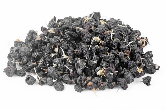 The Black wolfberries or black goji berries heap on white background.
