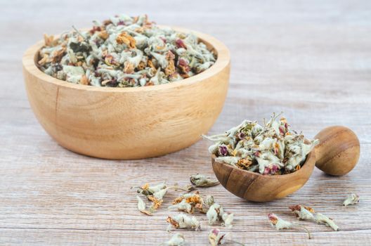 Flower tea. Dried of apple blossom in wooden spoon.