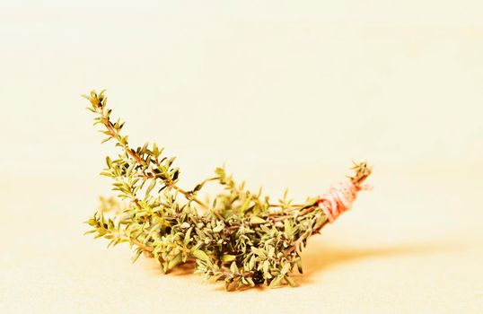 Bunch of fresh thymus on light wooden background, culinary herb