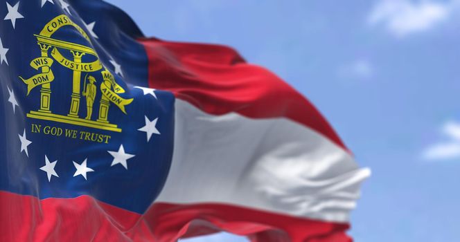 The state flag of Georgia waving in the wind. Georgia is a state in the Southeastern region of the United States. Democracy and independence.