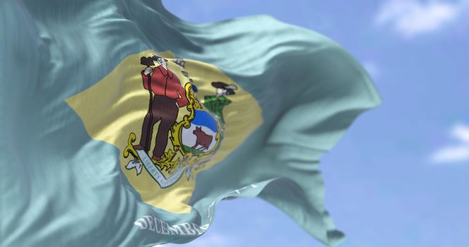 The state flag of Delaware waving in the wind. Delaware is a state in the Mid-Atlantic region of the United States. Democracy and independence. US state.