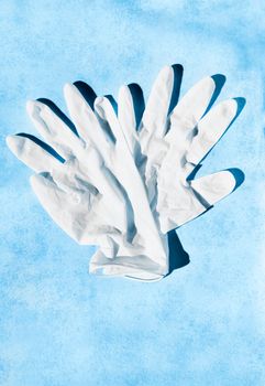 Pair of white surgical glove on blue background , health care and medicine