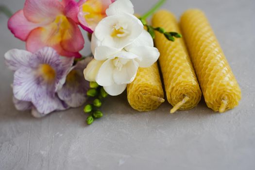 Natural honey wax candles. Set of candles. Environmentally friendly product. Bouquet of flowers. Fragrant multi-colored freesias.