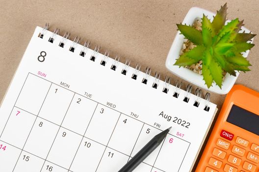 The August 2022 desk calendar with calculator.