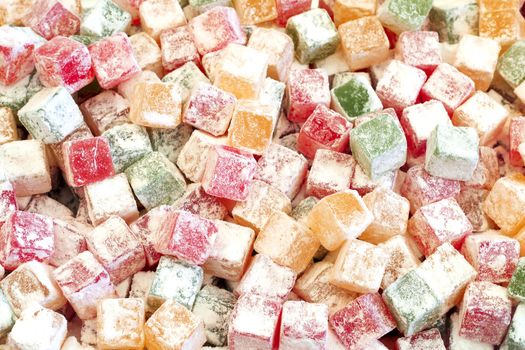 fruit paste sugar covered different colors candy background, top view