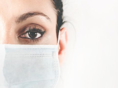 Surgical mask. Doctor in a medical mask. Close-up. Medical mask on woman face. Patient, nurse. Protection against COVID-19. Copy space.