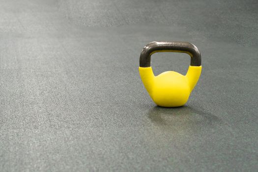 Yellow kettlebell weight healthy concept, from gym fit for bodybuilding and health single, bright tough. Pace colorful tudio, ettlebell dumbbell black fresh black background object