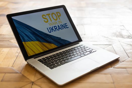 stop war and patriot. laptop, flag of ukraine.