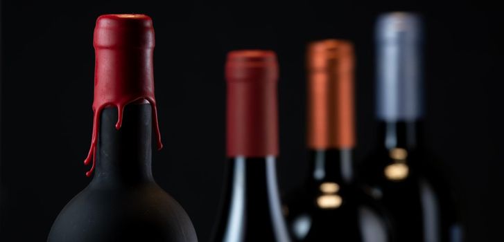 Set of collars red wine bottles isolated on black background, France