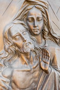 Bas-relief in bronze representing The Pity of Michelangelo. Faces of Holy Mary mother and Jesus Christ after the Crucifixion.