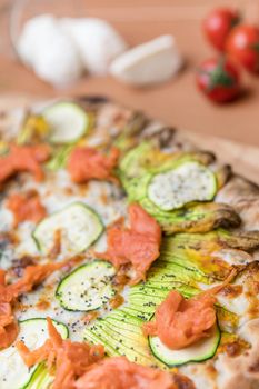 Delicious pizza with salmon and vegetables. italian pizza. Background. Top view. Flat lay.